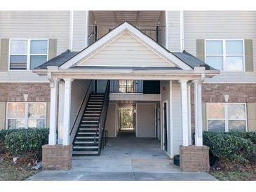 Apartment complex entrance featuring a covered stairwell and access to the units above at 10303 Waldrop Place, Decatur, GA 30034