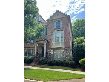 Charming brick townhome with stone accents and a manicured front yard at 3923 High Dove Sw Way # 16, Smyrna, GA 30082