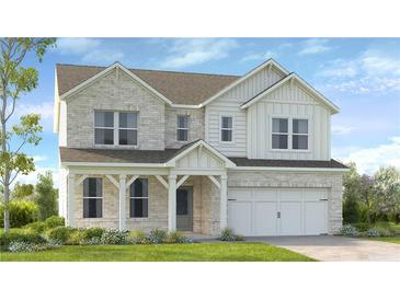 Charming two-story home featuring a welcoming porch, brick facade, and attached two-car garage at 1385 Windance Lake Dr, Loganville, GA 30052