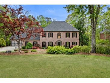 Charming brick home with a well-manicured lawn and mature landscaping at 3646 Sope Creek Farm Se, Marietta, GA 30067