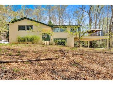 Charming two-story home with a bright exterior, lush front yard, and spacious covered deck for outdoor relaxation at 481 Patillo Rd, Stockbridge, GA 30281