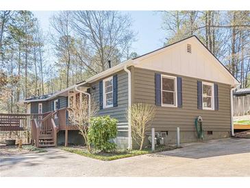 Charming home featuring blue shutters, wood siding, and a welcoming front porch at 524 S Holly Springs Rd, Woodstock, GA 30188