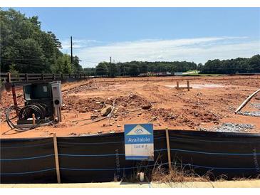 An available vacant lot showcases construction potential against a backdrop of trees and open sky at 6343 Towhee Way, Morrow, GA 30260
