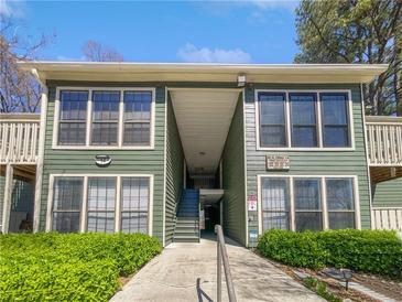 Two-story condo building with well-maintained landscaping and a pedestrian walkway at 4640 Vinings Central Se Run # 128, Atlanta, GA 30339