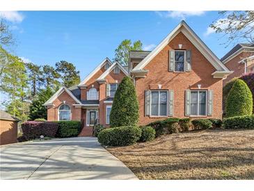 Charming brick home with manicured landscaping and a welcoming driveway at 1142 Hidden Spirit Trl, Lawrenceville, GA 30045