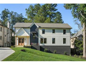 Stunning two-story home with a modern farmhouse design and lush green lawn at 2198 Oakawana Ne Dr, Atlanta, GA 30345