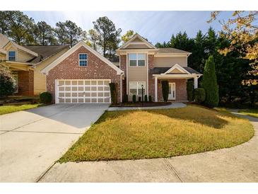 Charming two-story home featuring a brick facade, attached garage, and well-maintained front lawn at 742 Hope Hollow Ln, Loganville, GA 30052