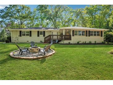 Beautiful backyard with brick firepit and a well-maintained lawn perfect for outdoor gatherings at 1155 Christian Se Cir, Conyers, GA 30013