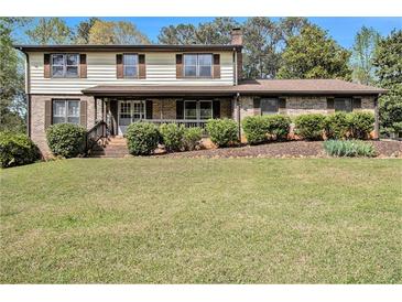 Charming two-story home with a covered front porch and well-maintained landscaping at 1757 Colonial South Sw Dr, Conyers, GA 30094