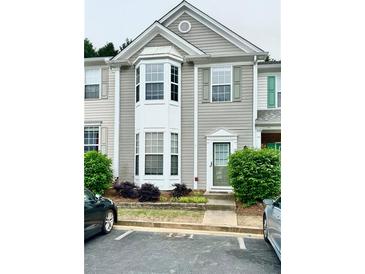 Inviting townhouse with a bay window, neutral siding, and well-maintained landscaping at 4645 Valais Ct # 121, Alpharetta, GA 30022