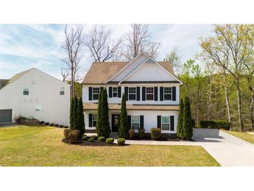 Charming two-story home with manicured front yard and black shuttered windows at 121 Shoals Bridge Rd, Acworth, GA 30102