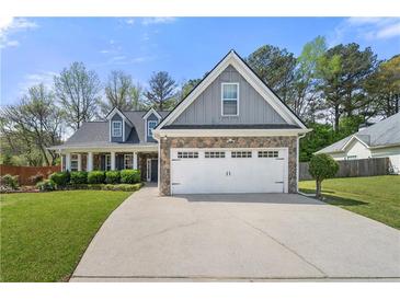 Charming two-story home with stone accents, a well-manicured lawn, and an attached two-car garage at 2232 Ann Ln, Lithia Springs, GA 30122