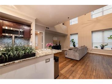 An open concept living room featuring wood floors and plenty of natural light at 2626 Peachtree Nw Rd # 412, Atlanta, GA 30305