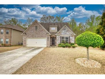 Charming single-Gathering home featuring a brick and stone facade, landscaped yard, and a two-car garage at 164 Madison Grace Ave, Mcdonough, GA 30252