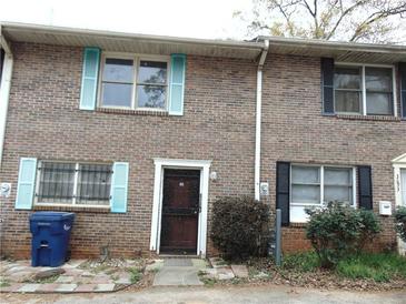 Brick townhouse with colorful shutters and well-maintained landscaping at 3695 Church St, Clarkston, GA 30021