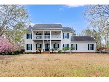Charming two-story home with a covered porch, balcony, and a spacious front yard at 3642 Falls Trl, Winston, GA 30187