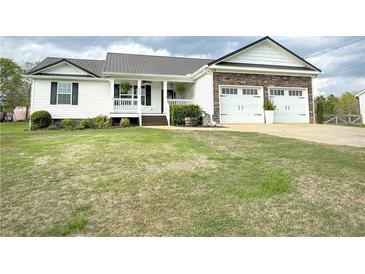 Charming home with a metal roof, stone accents, and a well-manicured lawn at 273 Crowe Springs Nw Rd, Cartersville, GA 30121