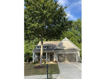 Charming one-story home with a well-maintained lawn, beautiful landscaping, and an attached two-car garage at 3455 Buffington Ln, Cumming, GA 30040