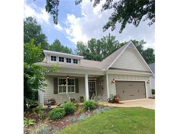 Charming single-story home featuring a well-manicured front yard and a two-car garage at 3455 Buffington Ln, Cumming, GA 30040