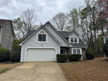 Charming home featuring a two-car garage, stone accents, and a well-maintained front yard at 995 Litchfield Pl, Roswell, GA 30076