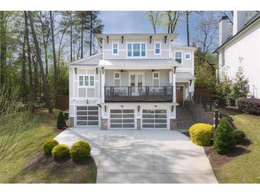 Stunning two-story home features a balcony, three-car garage, and professionally landscaped yard at 3080 Dickson Ne St, Brookhaven, GA 30319