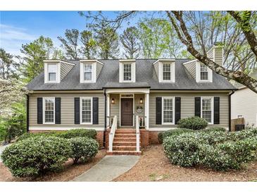 Charming home with a brick walkway, dormer windows and professionally landscaped yard at 4062 Silver Fir Ct, Marietta, GA 30066
