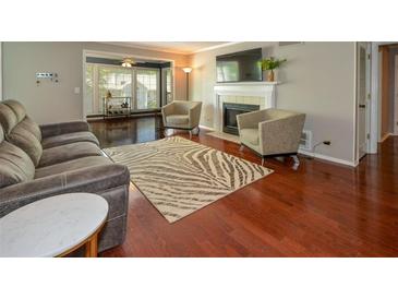 Comfortable living room features hardwood floors, a fireplace, and a cozy seating area at 1602 Gettysburg Pl, Sandy Springs, GA 30350