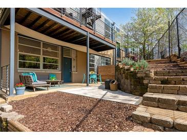 Cozy outdoor patio featuring comfortable seating and a dining area, perfect for relaxing and entertaining guests at 400 Village Ne Pkwy # 203, Atlanta, GA 30306