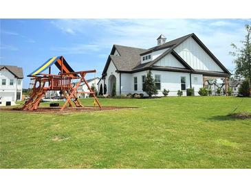 Beautiful single Gathering home with a spacious yard and wooden playset at 421 Auburn Valley Way, Auburn, GA 30011