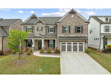 Charming two-story home with stone and brick facade and well-manicured lawn at 4229 Brookmont Way, Auburn, GA 30011