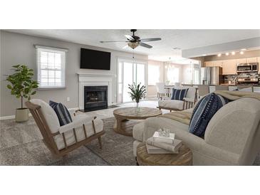 Inviting living room with a cozy fireplace, plush seating, and an open layout to the kitchen and dining area at 68 Hampshire Ct, Avondale Estates, GA 30002