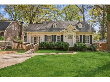 Charming single-story home with well-manicured lawn, complemented by lush landscaping and a welcoming entryway at 28 Exeter Rd, Avondale Estates, GA 30002