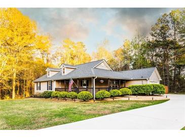 Charming home featuring a welcoming front porch and well-manicured landscaping and a flowing driveway at 20 Riverbrooke Rd, Covington, GA 30016