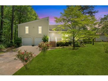 Charming home with a well-maintained lawn, mature trees, and an inviting front entrance at 112 Bernice Dr, Lawrenceville, GA 30045