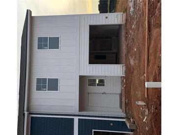 New construction two-story home showing the side entrance and garage at 1326 Riverstone Rd, Jonesboro, GA 30238