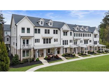 Beautiful townhome exteriors feature white siding, black trim, and inviting front porches at 2068 Cortland Rd, Milton, GA 30009