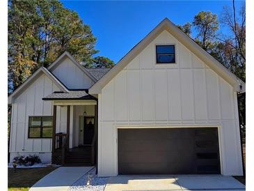 Charming new construction with board and batten siding and a two car attached garage at 2152 Castlewood St, East Point, GA 30344