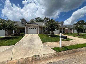 Charming one-story home featuring a well-maintained lawn and a private driveway leading to an attached garage at 340 Rosenwald Ln, Hampton, GA 30228