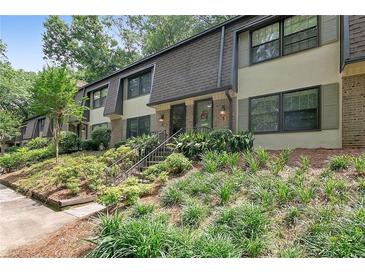 Charming townhouse featuring well-maintained landscaping and inviting entrance at 8 Arpege Nw Way, Atlanta, GA 30327