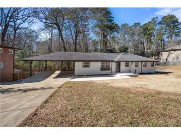 Charming single-story home features a covered carport and landscaped front yard at 2277 Cloverdale Se Dr, Atlanta, GA 30316