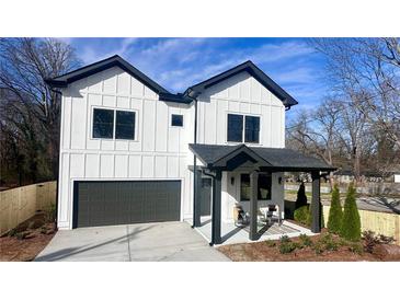 Charming new construction home with modern farmhouse design and welcoming covered porch at 3128 Cedar St, Scottdale, GA 30079