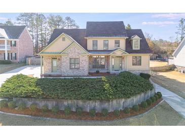 Inviting two-story home featuring a brick and siding facade, complemented by a meticulously landscaped front yard at 2006 Hubbard Ct, Villa Rica, GA 30180