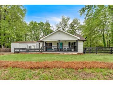 Charming renovated home with a welcoming front porch and well-maintained landscaping at 1965 Midway Rd, Douglasville, GA 30135