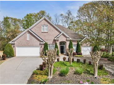 Charming brick home with a well-manicured lawn, two-car garage, and inviting front entrance at 3290 Winthrop Ne Cir, Marietta, GA 30067