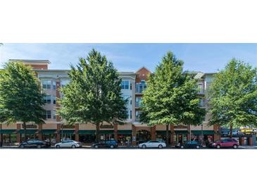 Attractive, low-rise building with street-level retail and lush mature trees lining the facade at 225 E Ponce De Leon Ave # 317, Decatur, GA 30030
