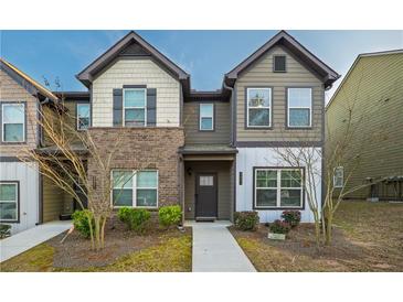 Charming two-story townhome with a mix of brick and siding, offering a welcoming front entrance at 2461 Bayrose Cir, Atlanta, GA 30344
