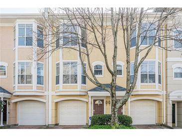 Charming townhome featuring bay windows, brick driveway, and attached one car garage at 375 Highland Ne Ave # 903, Atlanta, GA 30312
