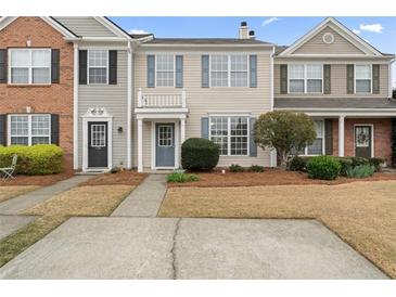 Charming townhouse with blue shutters and a well-maintained front yard at 1730 Stanwood Nw Dr, Kennesaw, GA 30152