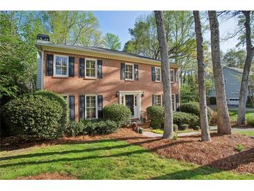 Charming two-story brick home with black shutters and a well-manicured lawn at 3141 Branford Ct, Marietta, GA 30062