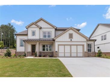 Charming two-story home with a manicured lawn, attached garage, and classic neutral color palette at 3315 Hillshire Dr, Cumming, GA 30028